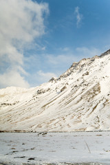 Winter in Iceland at the foot of the volcano. Snowy Icelandic mountain