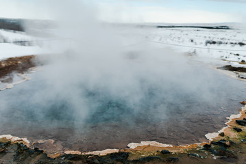 The colorful geyser landscape at the Haukadalur geothermal area, part of the golden circle route, in Iceland