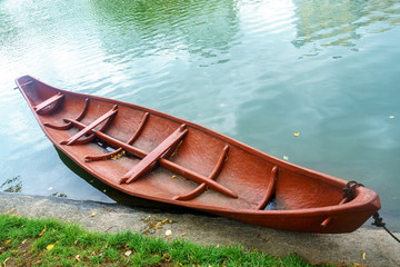 A wooden boat is moored to the shore