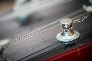 Close up of an electric guitar tuning post