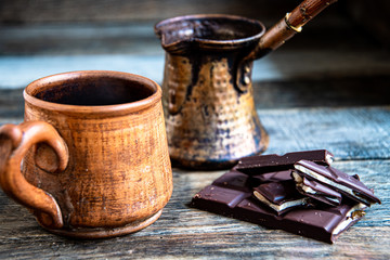 Home made turkish coffee with chocolate on a wooden table.