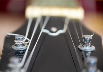Extreme close up of electric guitar tuning posts