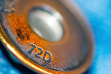 Close up of a pair of jeans' metal button
