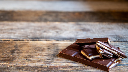 Chocolate with white filling on wooden boards.