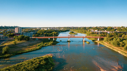 Fototapeta na wymiar Beautiful panoramic aerial view photo from flying drone to the Nemunas River and Petras Vileišis Bridge. Kaunas, Lithuania (series)