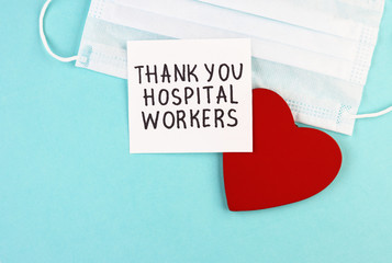 medical mask, healthy red heart and the inscription Thank you to hospital workers on a blue background
