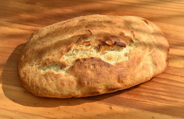 freshly baked bread on wooden cutting board isolated