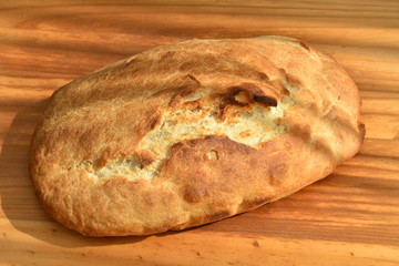 freshly baked bread on wooden cutting board isolated