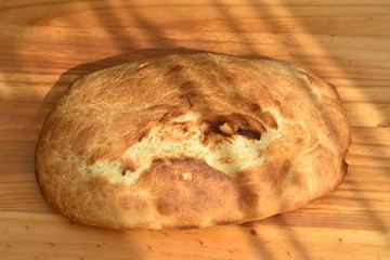 freshly baked bread on wooden cutting board isolated