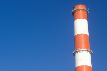 A red and white smoke stack at the Scattergood steam plant in Los Angeles, CA