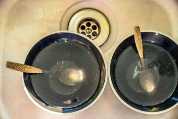 Dirty dishes stacked next to sink in home kitchen