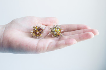 Male scientist or virologist with holds 3d model of covid-19 coronavirus in hand