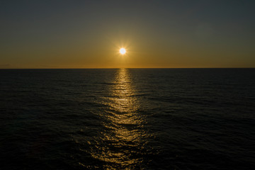 Fototapeta premium Amazing sunset captured over the sea serial shot from drone