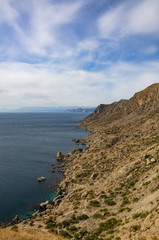 Mountain seascape, sunny day travel, and adventure.