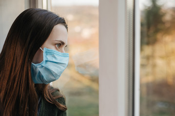 Close up of portrait upset young woman look far in window thinking about troubles, sad female in...