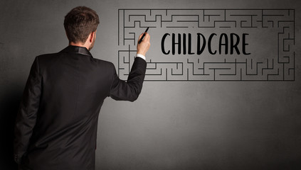 businessman drawing maze with CHILDCARE inscription, business education concept