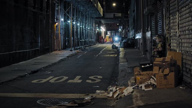 Urban New York City scenery, Manhattan narrow street by night, slow motion of people passing  