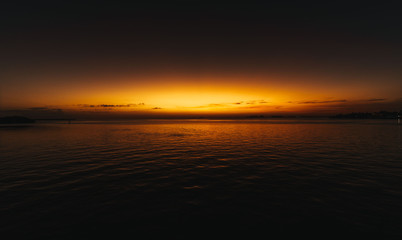 Fototapeta na wymiar sunset sea water sky ocean sun sunrise cloud beach nature landscape florida coast waves red orange dusk beautiful prints