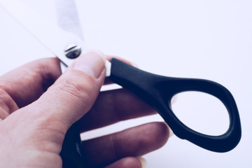 Female hand holds open stationery scissors close-up
