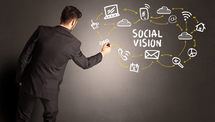 businessman drawing social media icons with SOCIAL VISION inscription, new media concept