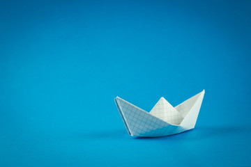 paper boat on a blue background, a boat floating on the water, a symbol of hope, origami, classic...