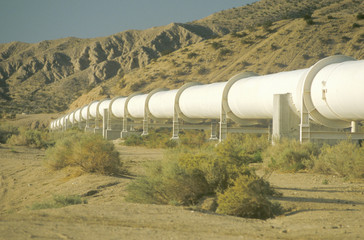 An aqueduct which supplies water to Los Angeles winding down a hill in the California desert