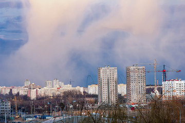 Fototapeta premium city view, multi-storey buildings under construction cranes.