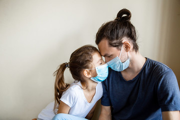 Stay at home family due coronavirus pandemic quarantine. Close up father and daughter in protective...