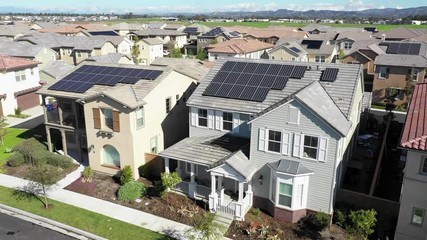 Aerial view above houses, solar project renewable energy panels on neighborhood