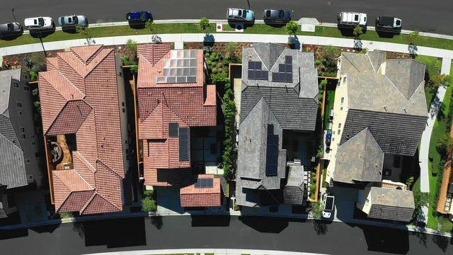 Birds eye aerial of houses with solar panels. Renewable energy on neighborhood homes