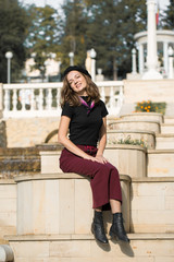 Fototapeta premium The girl in beret and skirt in the park