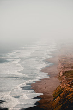 Misty Coastline and Waves