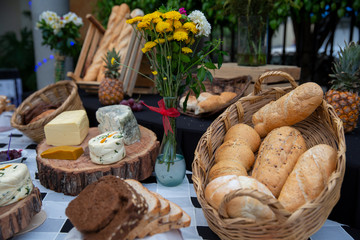 cheese table outdoors with baguettes