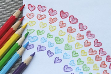Colored pencils with crayon child's drawing of a rainbow that during Covid-19 coronavirus pandemic...