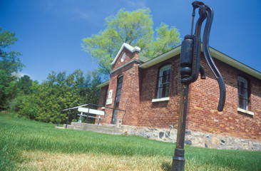 Fototapeta na wymiar Antique water pump and jailhouse, MI