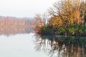 Autumn landscape featuring colorful trees reflecting in a lake in eastern Pennsylvania