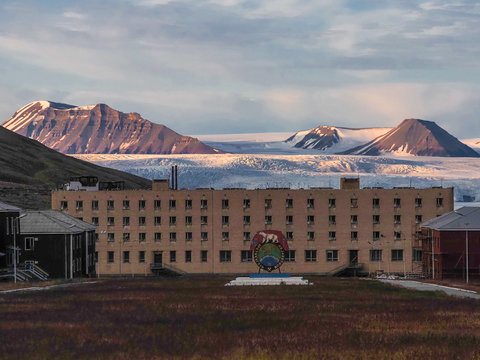 Pyramiden, Norway - August 2019: Abandoned Soviet/ Russian settlement Pyramiden in Svalbard archipelago. Building and socialist monument as a symbol of coal mining company.