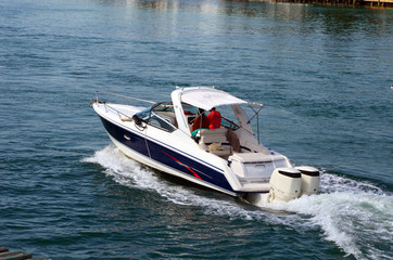 High-end blue and white motor boat powered by two outboard engines