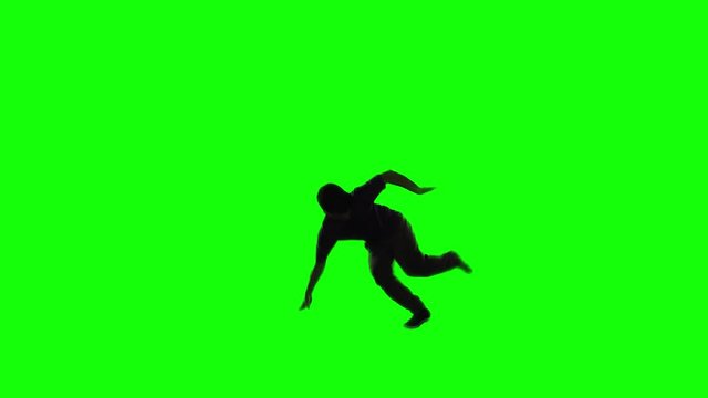 Silhouette of teenage boy doing break dance