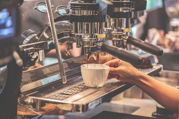 Barista is making coffee for customers in the coffee shop