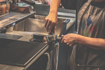 Barista is making coffee for customers in the coffee shop
