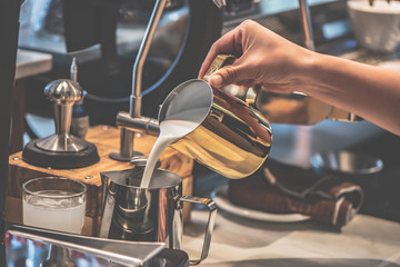 Barista is making coffee for customers in the coffee shop