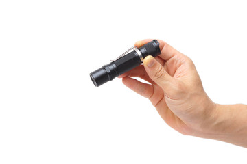Hand holding a small LED torch isolated / Flashlight for everyday use