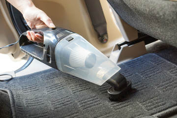 Cleaning a car using a vacuum cleaner