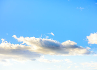 Beautiful puffy clouds at sunset isolated against pastel blue skies