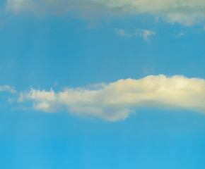 Beautiful puffy clouds at sunset isolated against pastel blue skies