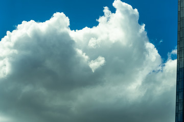 Beautiful puffy clouds at sunset isolated against pastel blue skies