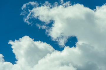 Beautiful puffy clouds at sunset isolated against pastel blue skies