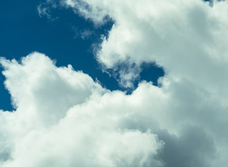 Beautiful puffy clouds at sunset isolated against pastel blue skies