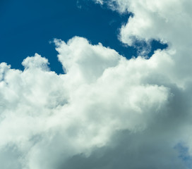 Beautiful puffy clouds at sunset isolated against pastel blue skies